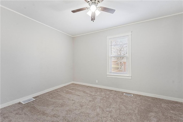 spare room featuring carpet flooring, ceiling fan, and crown molding