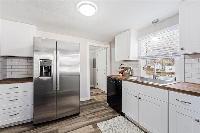 kitchen featuring dishwasher, stainless steel fridge with ice dispenser, butcher block counters, and sink