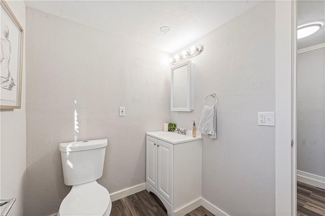 bathroom featuring hardwood / wood-style flooring, vanity, and toilet