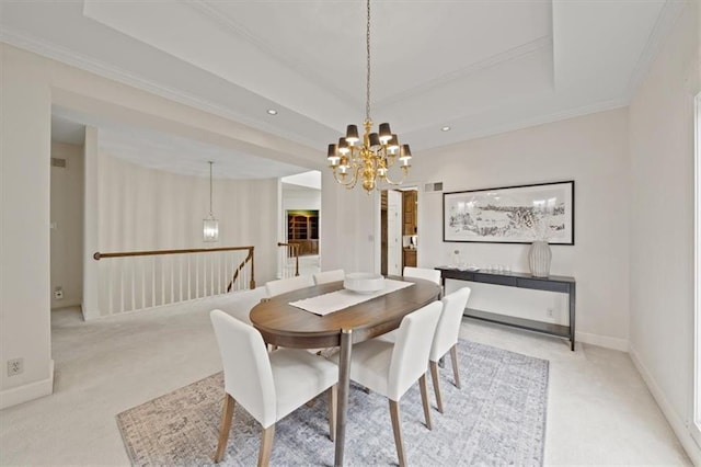 carpeted dining space featuring a tray ceiling, crown molding, and a notable chandelier