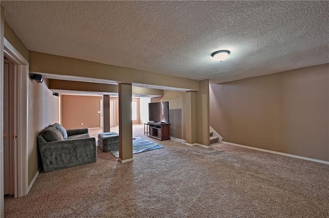 basement featuring carpet and a textured ceiling