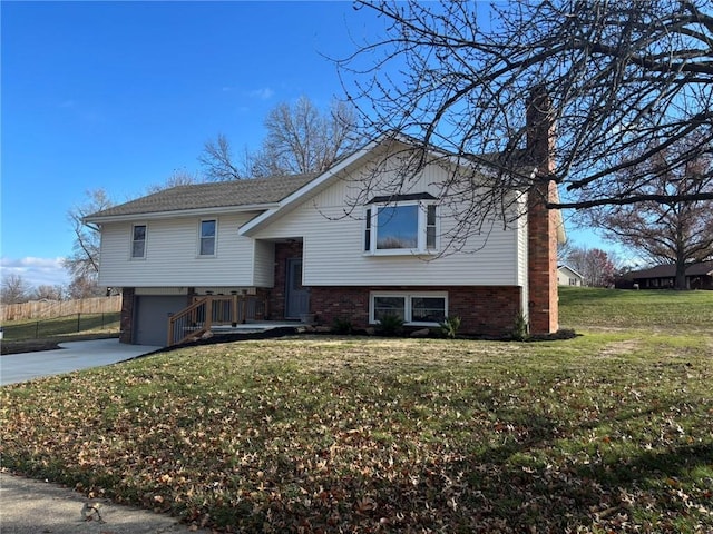 split foyer home featuring a front yard and a garage