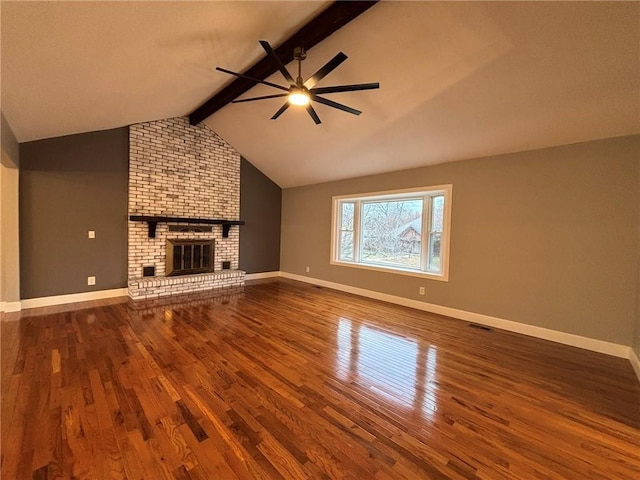 unfurnished living room with vaulted ceiling with beams, a fireplace, visible vents, wood finished floors, and baseboards