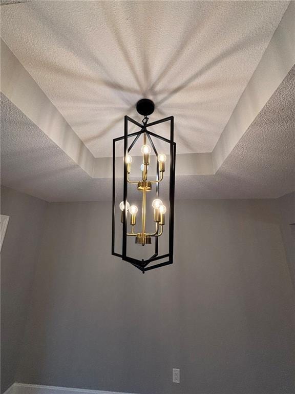 interior details with a textured ceiling and an inviting chandelier