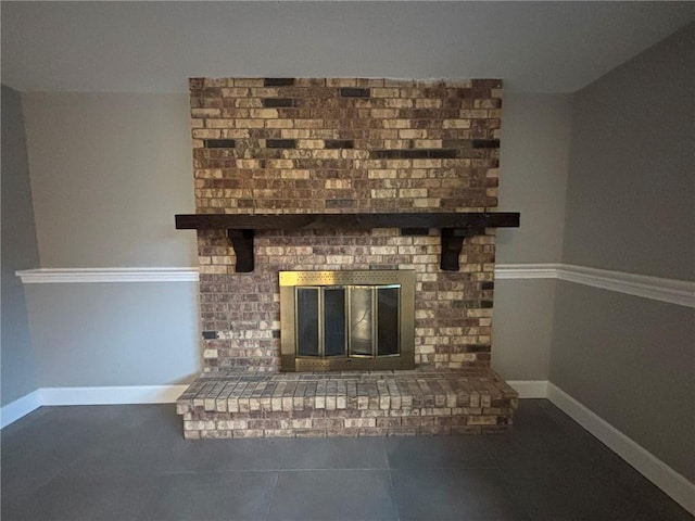 room details featuring a fireplace and baseboards