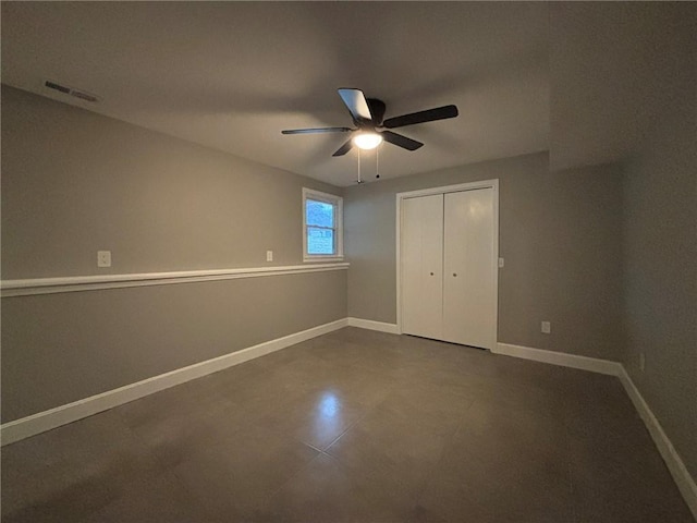 unfurnished bedroom featuring a closet, visible vents, ceiling fan, and baseboards