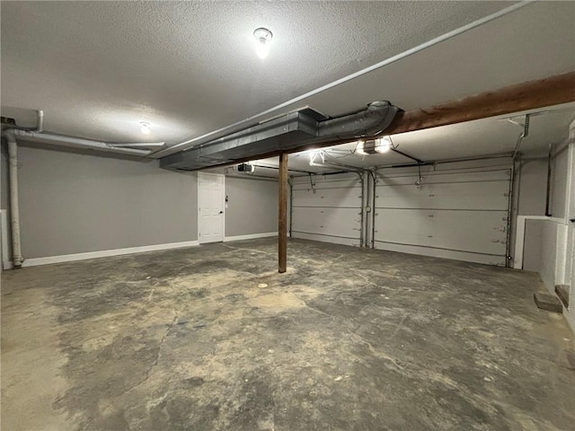 garage featuring a garage door opener and baseboards