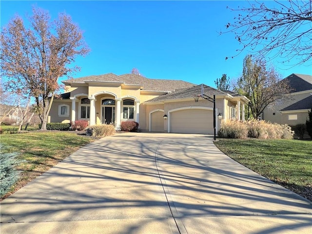 view of front of home featuring a garage and a front lawn