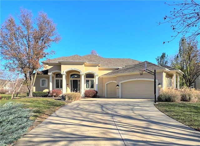 view of front of house with a garage and a front lawn