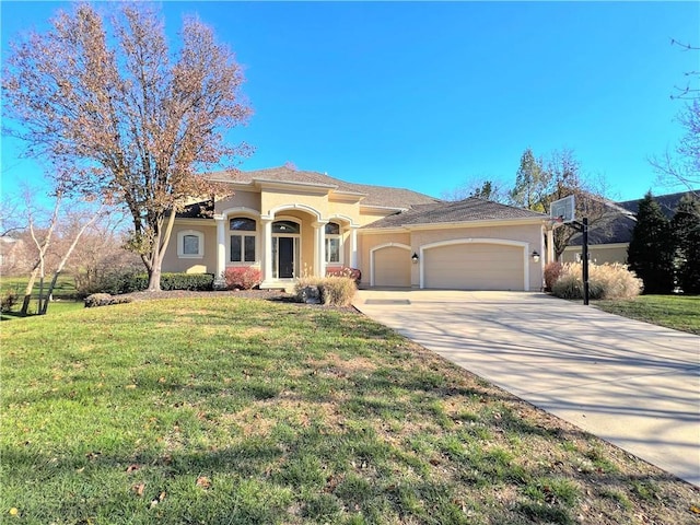 view of front of house with a front yard and a garage