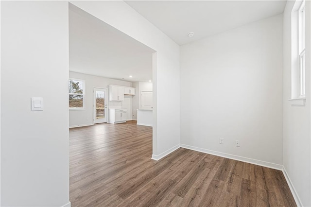 empty room with recessed lighting, wood finished floors, and baseboards