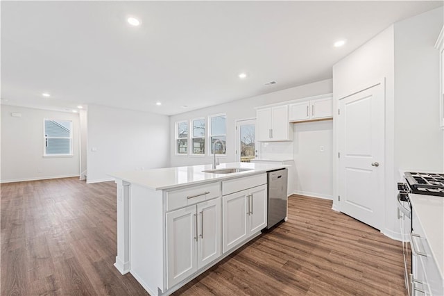 kitchen featuring light countertops, a sink, a kitchen island with sink, and stainless steel appliances