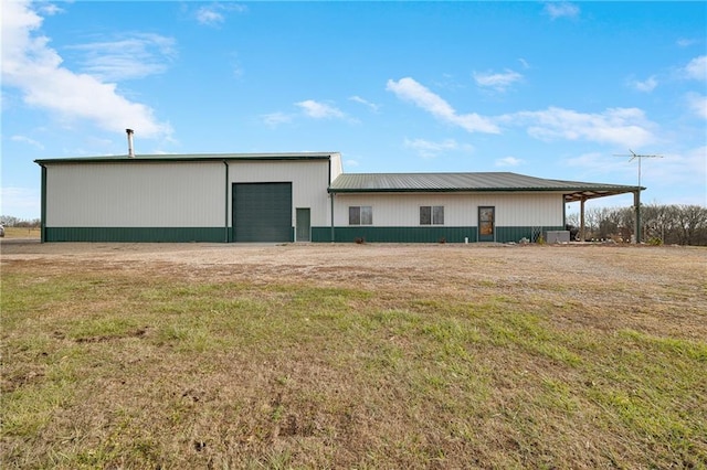 exterior space with an outbuilding, a yard, and a garage