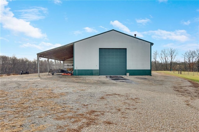 view of outbuilding featuring a carport and a garage