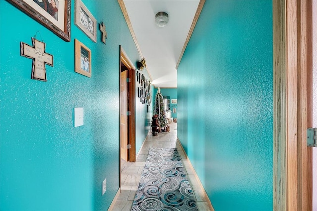 hallway with crown molding and light tile patterned flooring