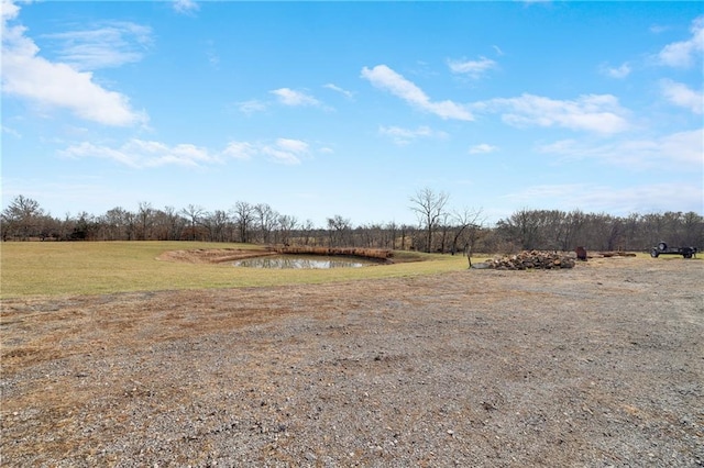 view of yard with a rural view and a water view