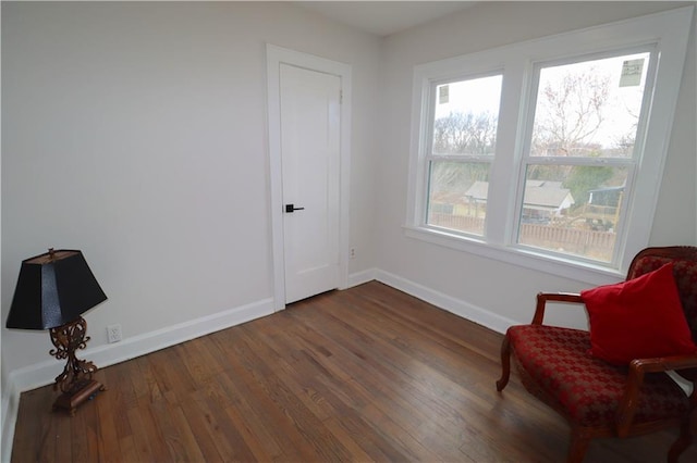 sitting room with dark wood-type flooring