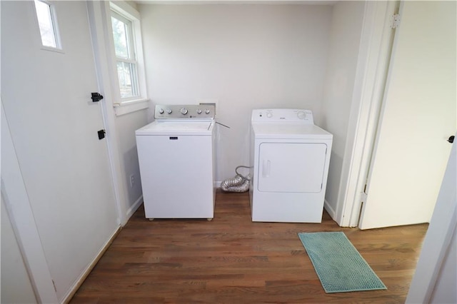 washroom with dark wood-type flooring and washing machine and dryer