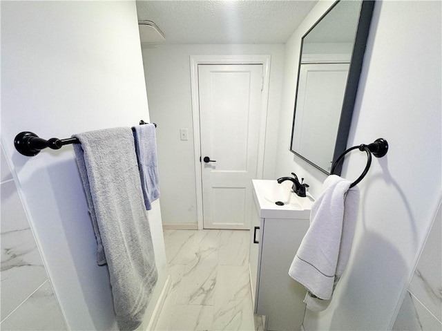 bathroom featuring vanity and a textured ceiling