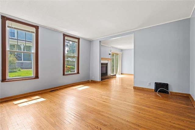 unfurnished living room featuring light wood-type flooring