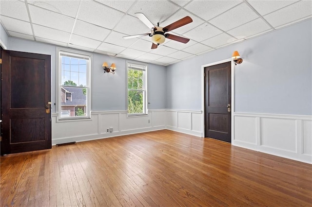 foyer entrance with a paneled ceiling, ceiling fan, and wood-type flooring