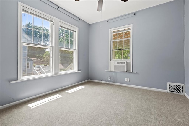 empty room with carpet floors, cooling unit, and ceiling fan