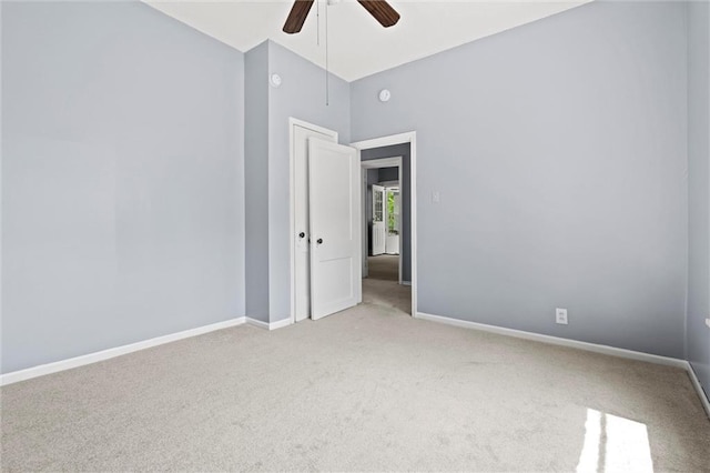 carpeted spare room with ceiling fan