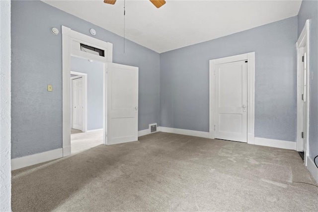 unfurnished bedroom featuring carpet flooring, ceiling fan, and lofted ceiling