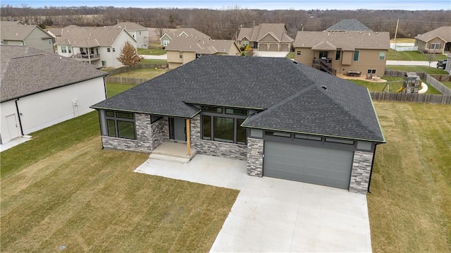 view of front of property featuring a front lawn and a garage