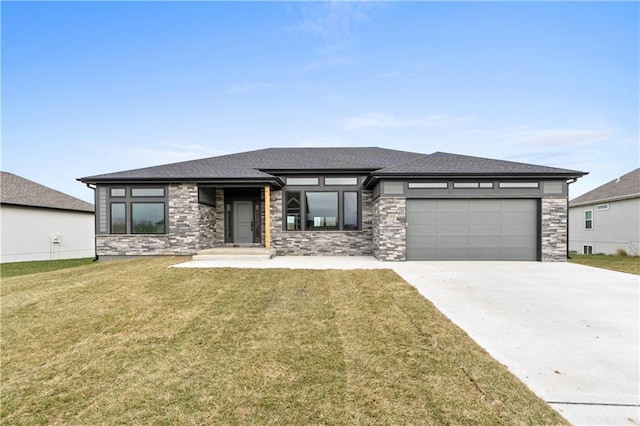 prairie-style house featuring a front yard and a garage