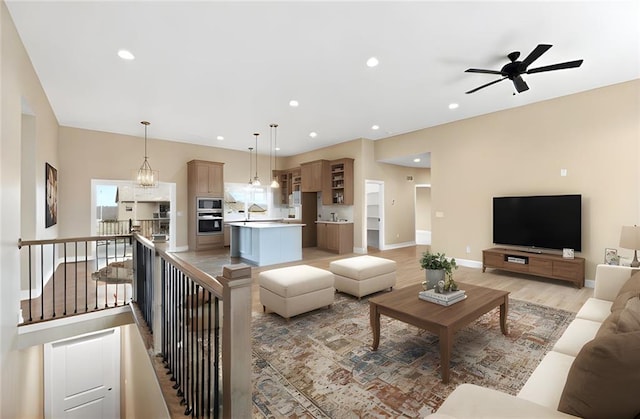 living room featuring sink and light hardwood / wood-style floors