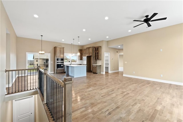 interior space with ceiling fan, sink, and hardwood / wood-style floors