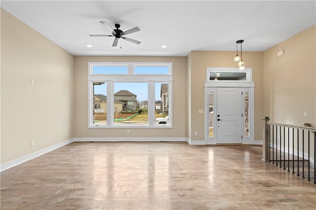 foyer featuring ceiling fan and light wood-type flooring