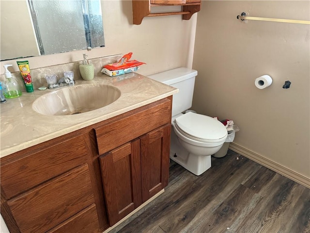 bathroom with vanity, toilet, and wood-type flooring