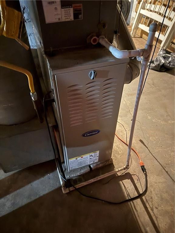 utility room featuring heating unit