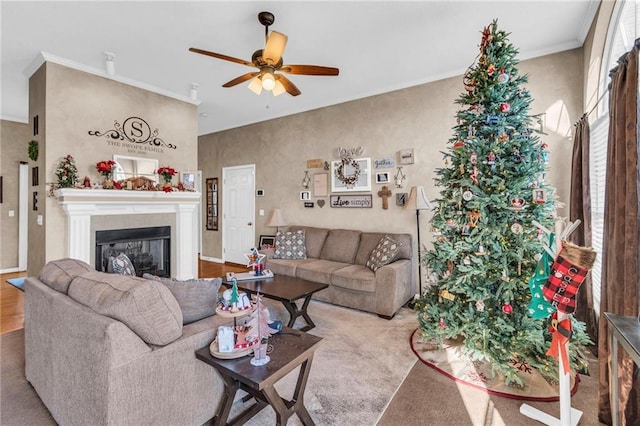 living room featuring ceiling fan, crown molding, and light carpet