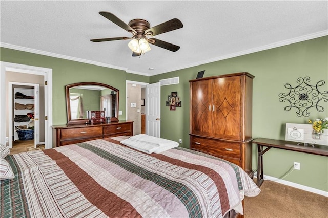 carpeted bedroom featuring a textured ceiling, ceiling fan, and crown molding