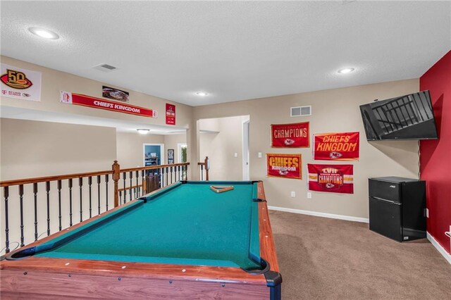 rec room with carpet floors, a textured ceiling, and pool table