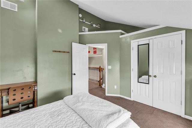 bedroom featuring a closet, carpet, and lofted ceiling