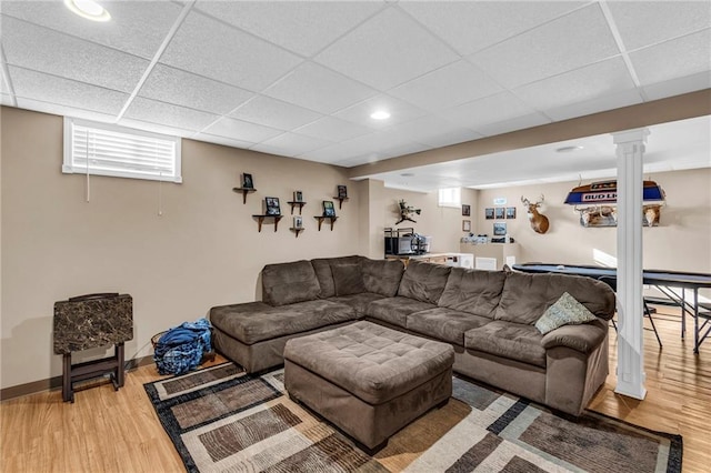 living room with a drop ceiling and hardwood / wood-style flooring