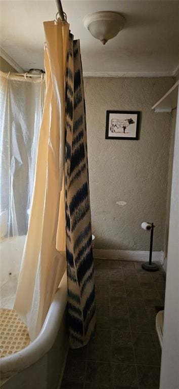 bathroom with tile patterned floors and shower / bath combo with shower curtain