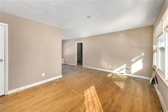 spare room with wood-type flooring