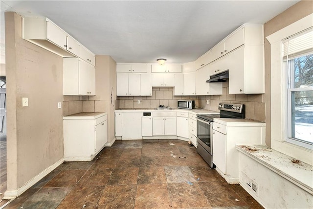 kitchen featuring appliances with stainless steel finishes, white cabinets, sink, and tasteful backsplash