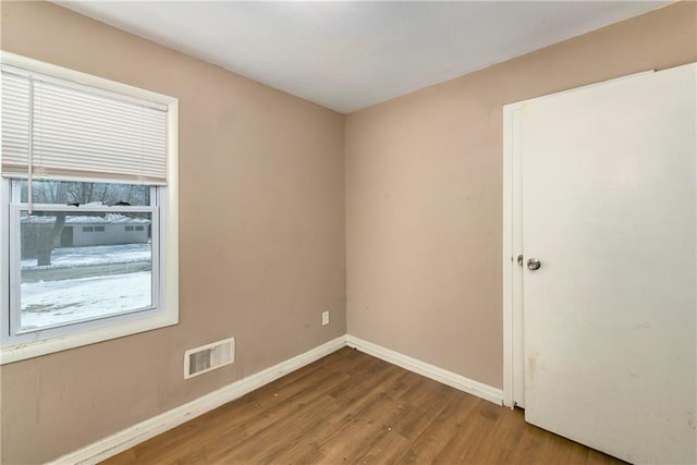 unfurnished room featuring wood-type flooring