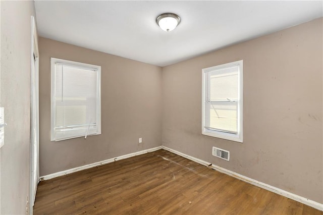 spare room featuring dark hardwood / wood-style floors