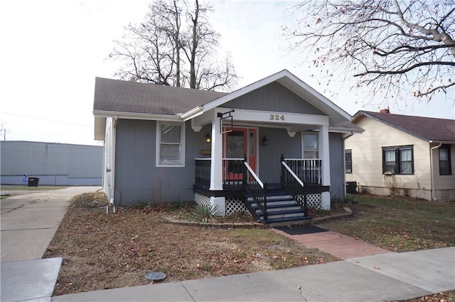 bungalow-style home featuring covered porch and central air condition unit