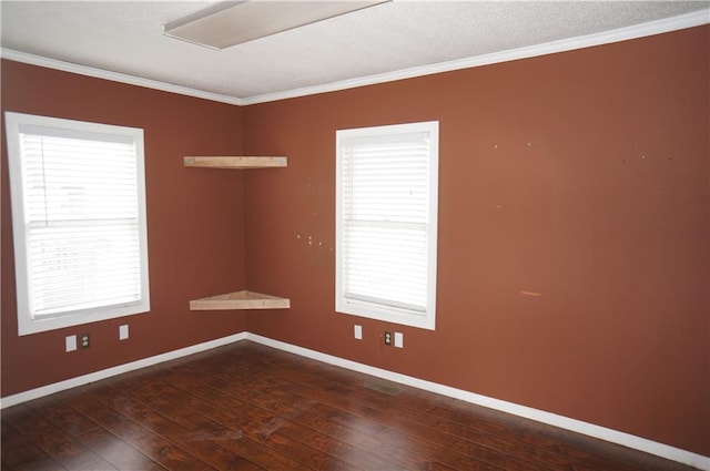 unfurnished room with a wealth of natural light, dark hardwood / wood-style flooring, a textured ceiling, and ornamental molding