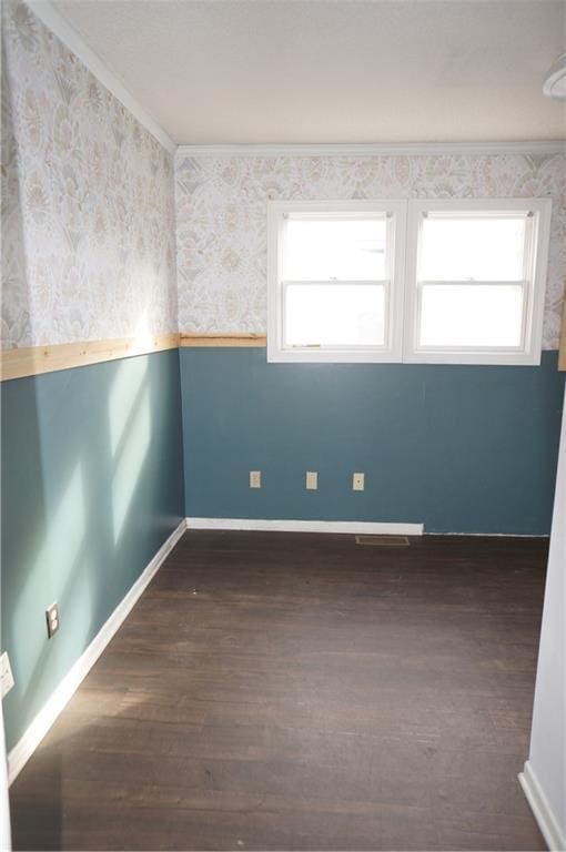 unfurnished room featuring crown molding and dark wood-type flooring