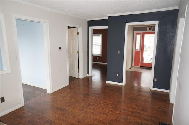 spare room with a textured ceiling, crown molding, and dark hardwood / wood-style floors