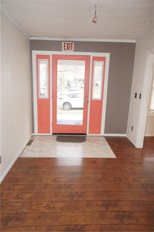 entrance foyer with ornamental molding, a textured ceiling, and hardwood / wood-style flooring